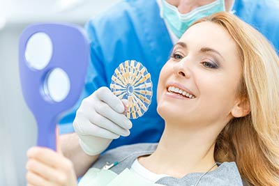 cosmetic dentistry patient choosing which dental veneer shade she would like